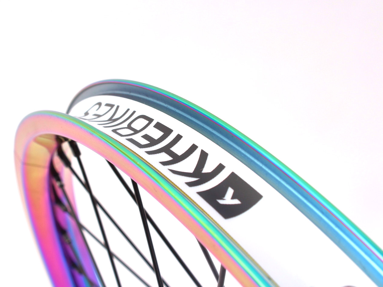 Oil Slick Felge mit weißem Felgenband und schwarzem KHEbikes Schriftzug Nahaufnahme 32mm breiter Doppelkammerfelge mit Felgenband von oben